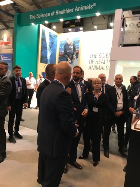 Norway's Crown Prince Haakon and Nor-Fishing Foundation chair Liv Holmefjord talk to Benchmark's CleanTreat team on the opening day of Aqua Nor this week