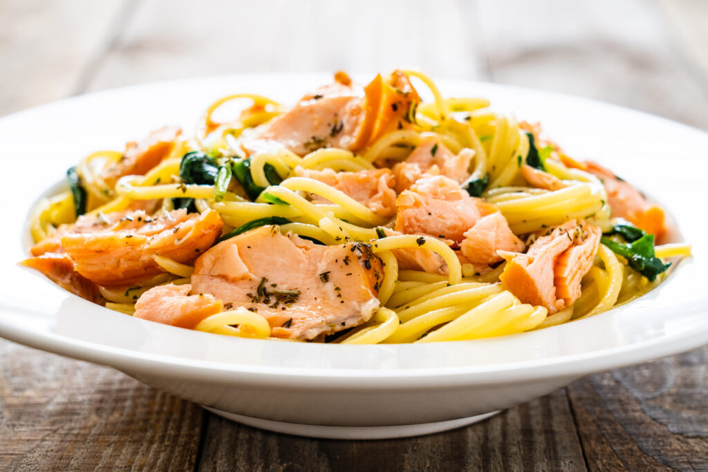 Pasta,With,Salmon,And,Spinach,On,Wooden,Background