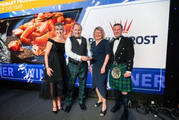 Bakkafrost Scotland Managing Director Iain Laister (2nd from left) with Su Cox receiving the company’s Primary Producer of the Year award at the 
Highlands and Islands Food and Drink Awards, 2023.
