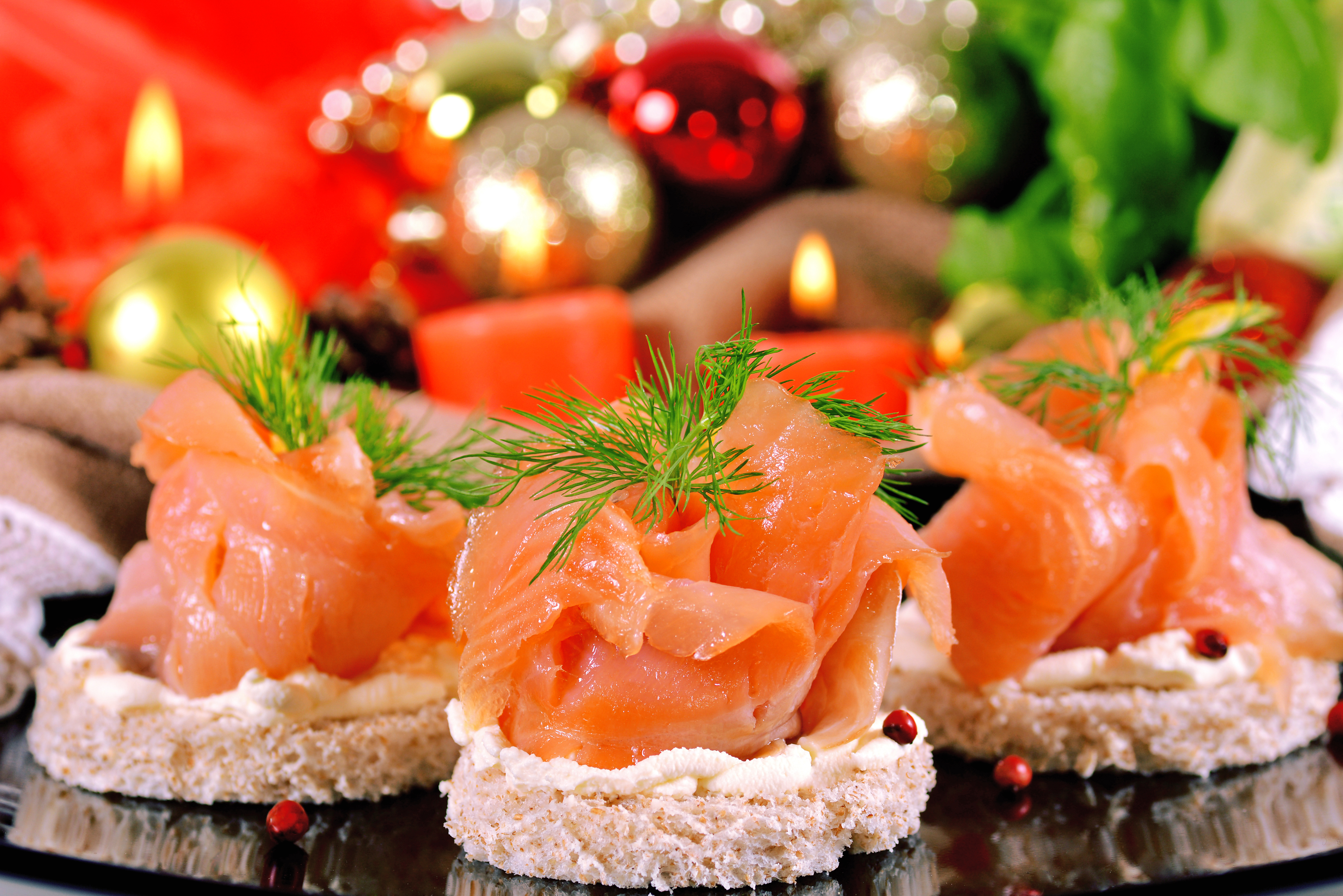 Holiday appetizer with salmon canapes on a background of Christmas decorations