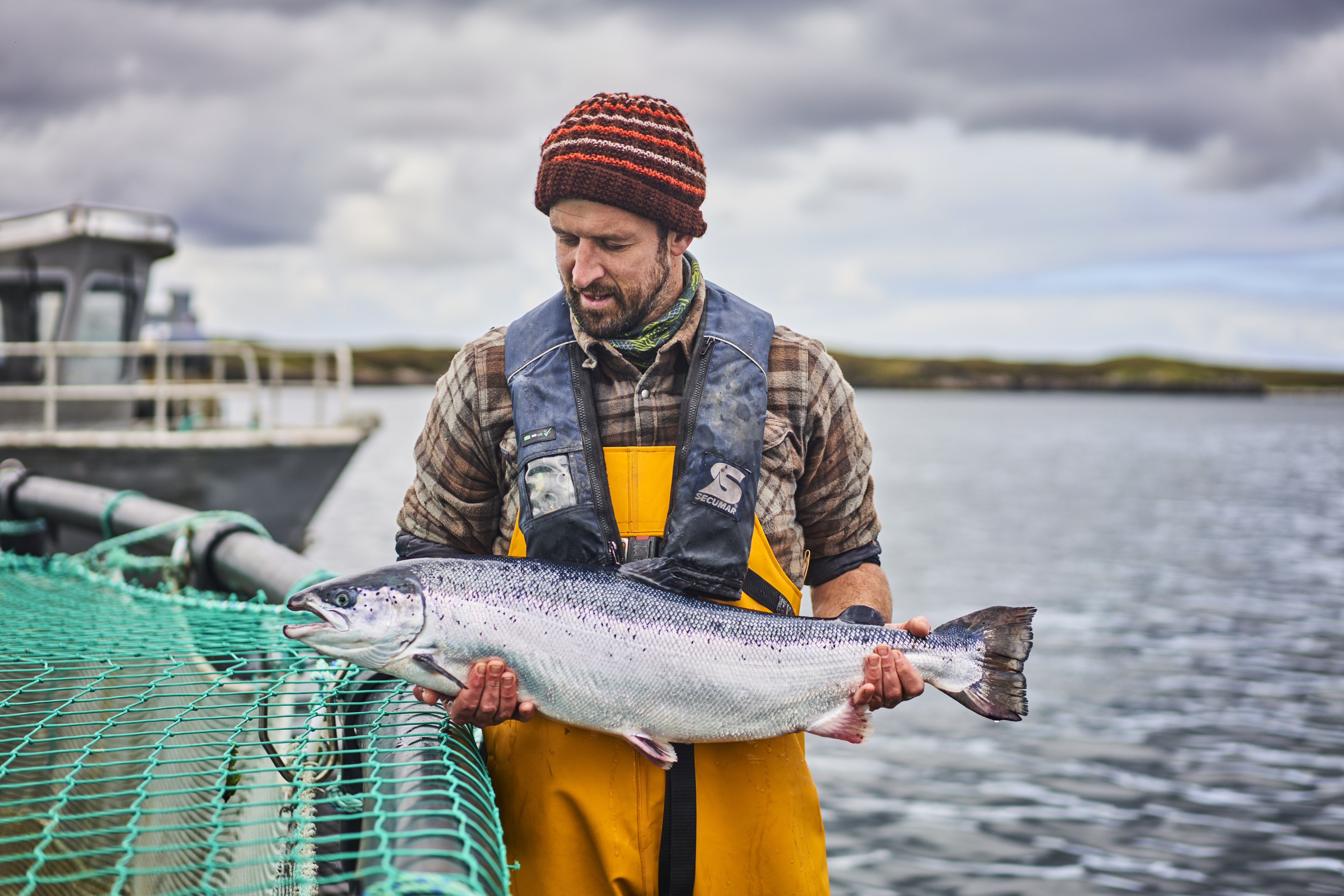Loch Duart worker on farm with salmon