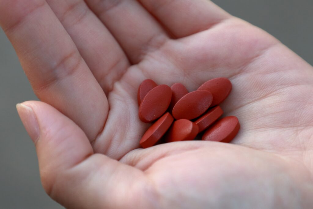 iron supplement tablets in woman's hand